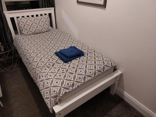 a small bed with a blue pillow on it at Amy's Place Charming 3 Bed House Donegal Sleeps 5 in Donegal