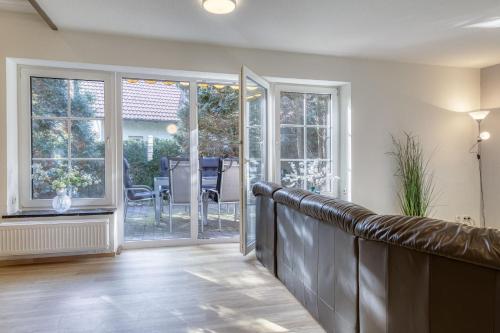 a living room with sliding glass doors and a porch at Landhus mit Terrasse in Alt Schwerin