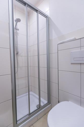 a shower with a glass door in a bathroom at Hotel Kehrenkamp in Hagen