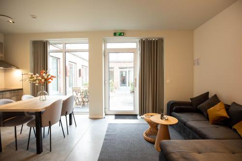 a living room with a couch and a table at City Housing Genk in Genk