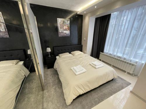 a bedroom with two beds with towels on them at Luxury Central Apartment Verila in Sofia