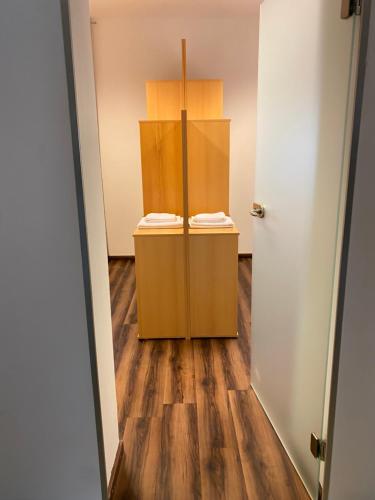 an empty room with a door and a wooden floor at Apartment Hafingerweg 11/EG in Sankt Pölten