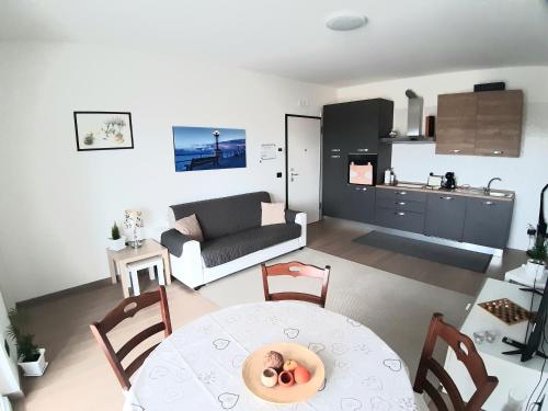 a living room with a table and a kitchen at Boulevard Suite in Bari