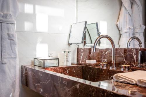 a bathroom counter with two sinks and a mirror at Vista Palazzo - Small Luxury Hotels of the World in Como