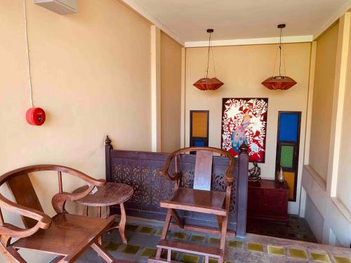 a room with two chairs and a table and a painting at Thapae Boutique House in Chiang Mai