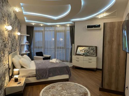 a bedroom with a bed and a tv in it at Meqafun Sea View apartment in Baku