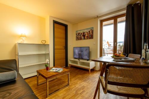 a living room with a couch and a table at Apartmenthotel Oberstdorf in Oberstdorf