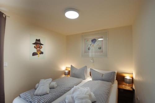 a bedroom with two beds with towels on them at Apartmenthotel Oberstdorf in Oberstdorf