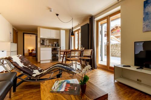 a living room with a couch and a table at Apartmenthotel Oberstdorf in Oberstdorf