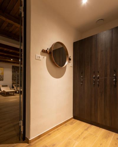 a mirror on a wall next to a door at Guest House Valentincic in Nova Gorica