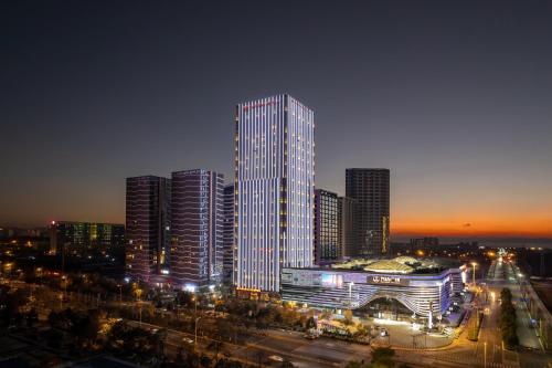 a tall building in a city at night at Wanda Realm Kunming in Kunming