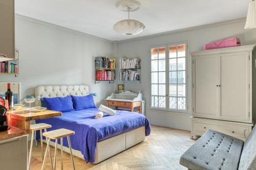 a bedroom with a bed and a table and a desk at Perfect Parisian Apartment LeMarais for you! in Paris