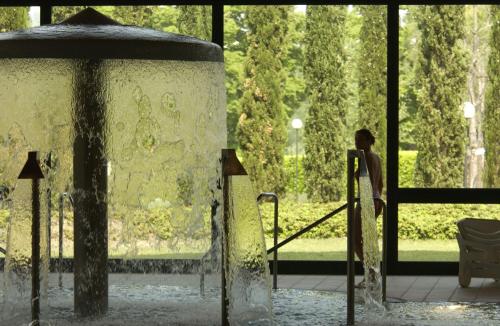 a statue of a woman standing in front of a fountain at Grand Hotel Terme in Riolo Terme