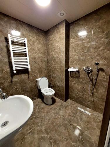 a bathroom with a toilet and a sink at Appartament Samgori in Tbilisi City