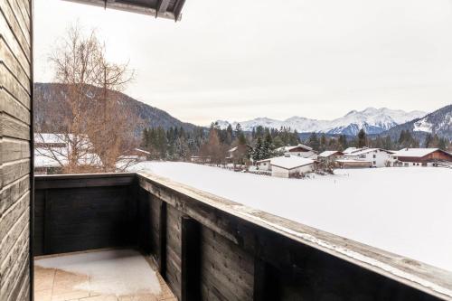 a balcony with a view of snow covered mountains at Fewo 2 Haus am Lärchenhang Leutasch in Leutasch