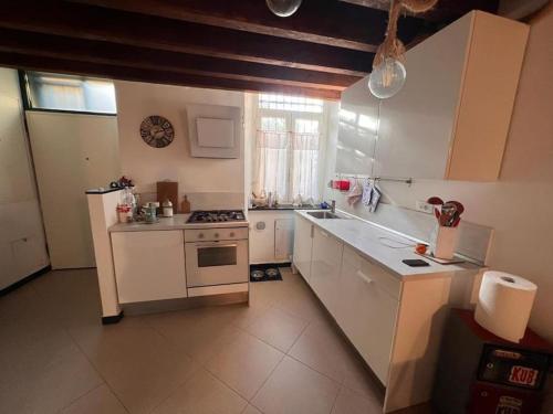 a kitchen with white counters and a stove top oven at Casa ORRI by Farris & Cors in Genoa