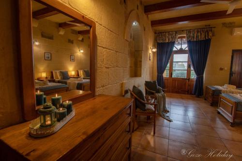 a large room with a mirror and a living room at Ta' Salvu Holiday Home in Xagħra