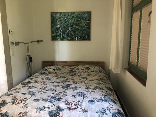 um quarto com uma cama com um edredão floral em Ferienwohnung Villa Barbara auf der sächsischen Weinroute em Radebeul