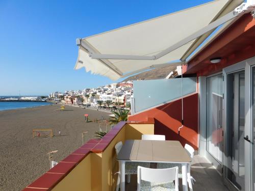 a balcony with a view of the beach at PERLA Penthouse in Gran Tarajal