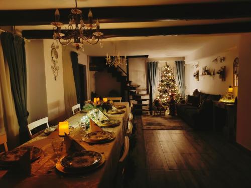 a living room with a table and a christmas tree at Vila Chic M in Moieciu de Jos