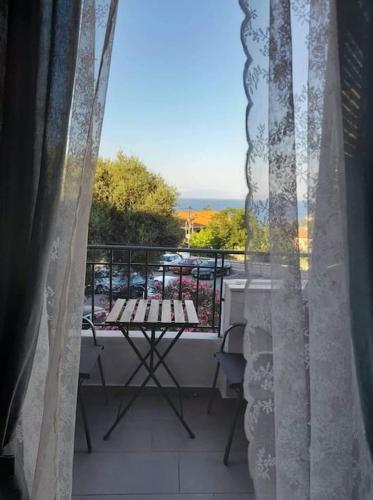 a view from a window of a balcony with a table at Διαμέρισμα με θέα θάλασσα στην περιοχή της Αθύτου in Afitos