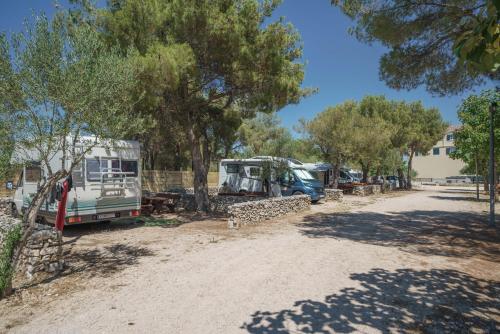 a group of rvs parked in a dirt road at Camping Vrata Krke in Lozovac