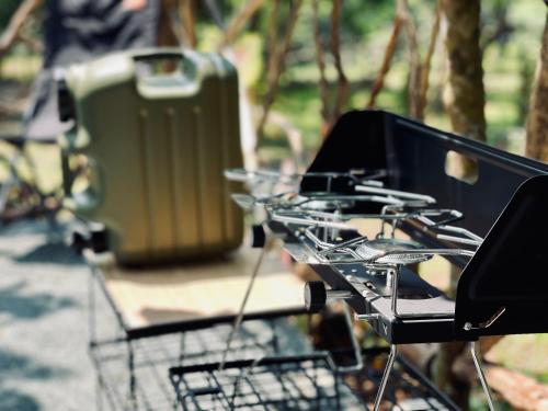 a shopping cart filled with wine glasses and a suitcase at Windfarm Nature Escape in Pililla