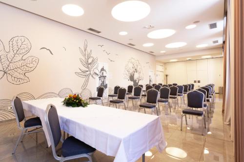 a room with a long table and chairs in a room at Hotel Continental in Rijeka