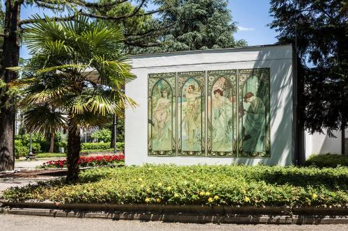 a large mural of nuns on a wall in a park at Grand Hotel Terme in Riolo Terme