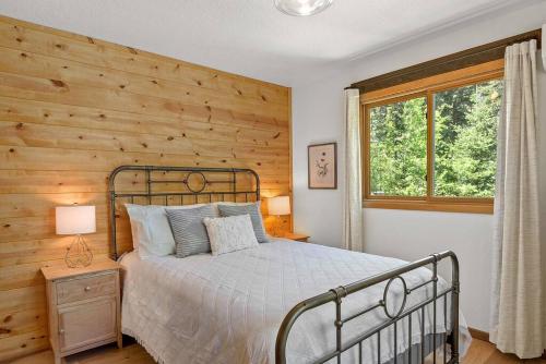 a bedroom with a bed and a wooden wall at Nature Stay with Views Like No Where Else in Custer