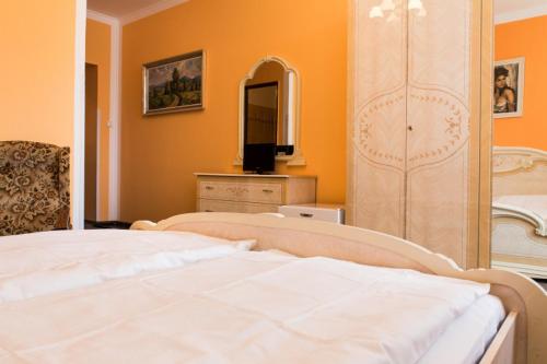 a bedroom with a bed and a dresser with a mirror at Penzion na Čertovce in Dolní Orlice