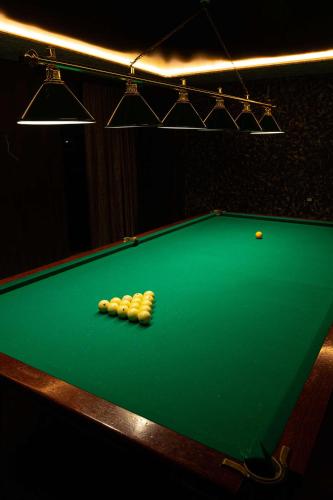 a green pool table with four balls on it at Alaska Resort in Tsaghkadzor