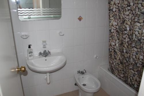 a bathroom with a sink and a toilet at Apartamentos Nautilus in Bajamar