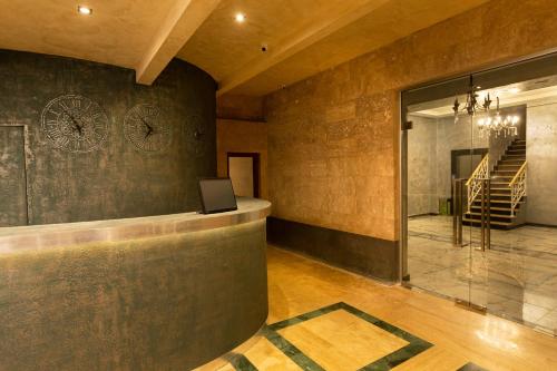 a lobby with a clock on the wall at Alaska Resort in Tsaghkadzor
