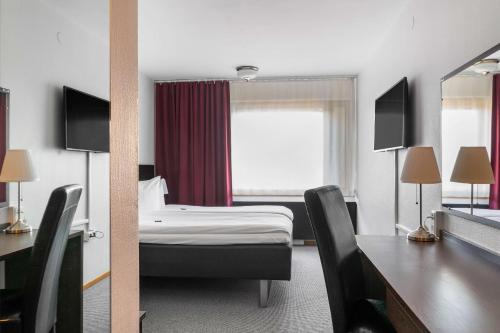 a hotel room with a bed and a desk at Best Western Malmia Hotel in Skellefteå