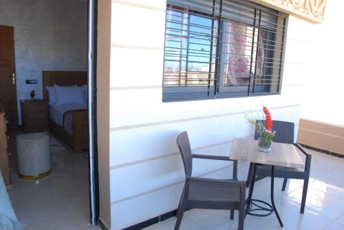 a room with a table and chairs and a bed at Moonrise Villa VIP Midelt in Midelt