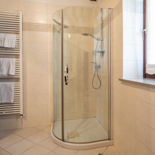 a shower with a glass door in a bathroom at Guest House Valentincic in Nova Gorica