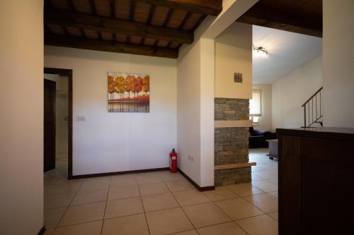 a living room with a fireplace and a painting on the wall at Guest House Valentincic in Nova Gorica