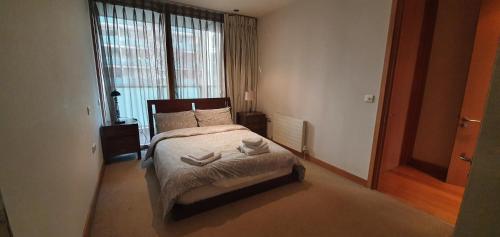 a bedroom with a bed with two towels on it at Central Prime King Size Apartment in Dublin