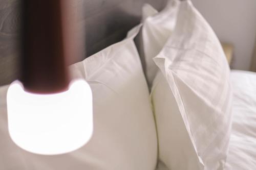 a close up of a white shirt and a pillow on a bed at Alaska Resort in Tsaghkadzor