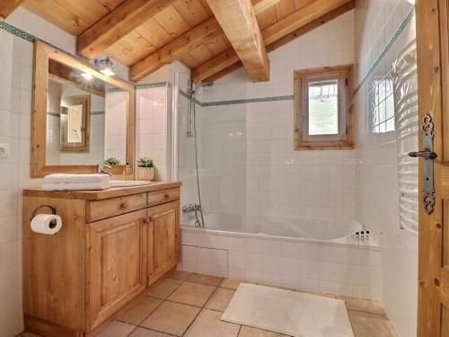 a bathroom with a tub and a sink at Chalet Morzine, 7 pièces, 8 personnes - FR-1-627-23 in Morzine
