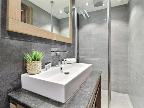 a bathroom with a white sink and a mirror at Appartement Morzine, 4 pièces, 9 personnes - FR-1-627-27 in Morzine