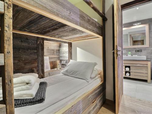 a bedroom with a wooden bunk bed with a mirror at Appartement Morzine, 4 pièces, 9 personnes - FR-1-627-27 in Morzine