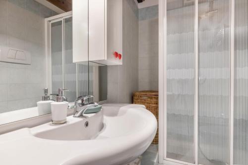 a white bathroom with a sink and a shower at Casa Giuly in Mirano