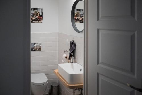 a bathroom with a white sink and a toilet at Válibor Vinotéka Apartman in Badacsonytomaj