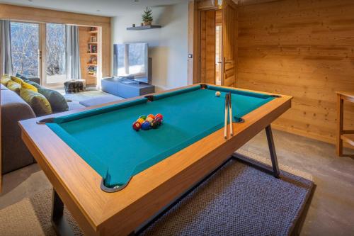 a living room with a pool table in a room at Chocolat Manigod - OVO Network in Manigod