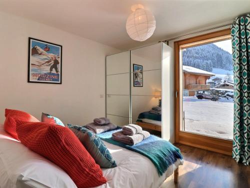 a bedroom with a bed and a window with a view at Chalet Morzine, 6 pièces, 10 personnes - FR-1-627-24 in Morzine