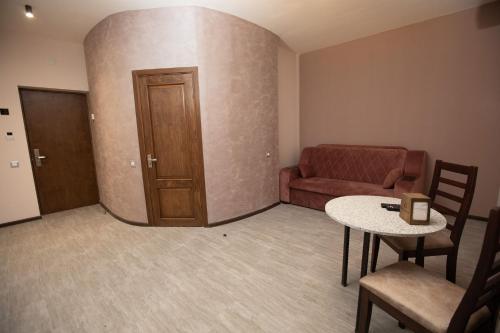 a living room with a couch and a table at Alaska Resort in Tsaghkadzor