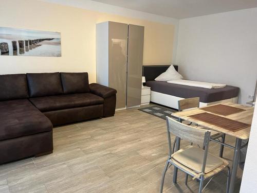 a living room with a couch and a bed at ForstStay Apartment in Forst