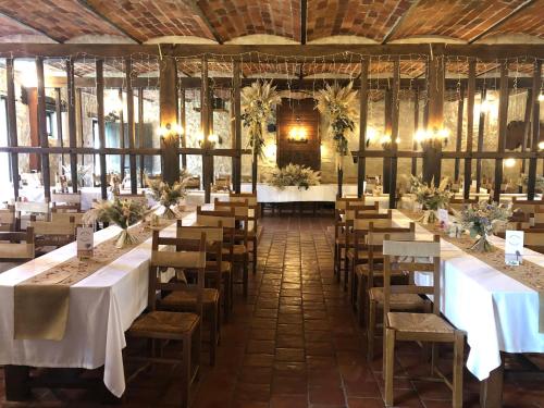 a large room with tables and chairs in it at Domaine Des Médards in Beaulieu-sur-Loire